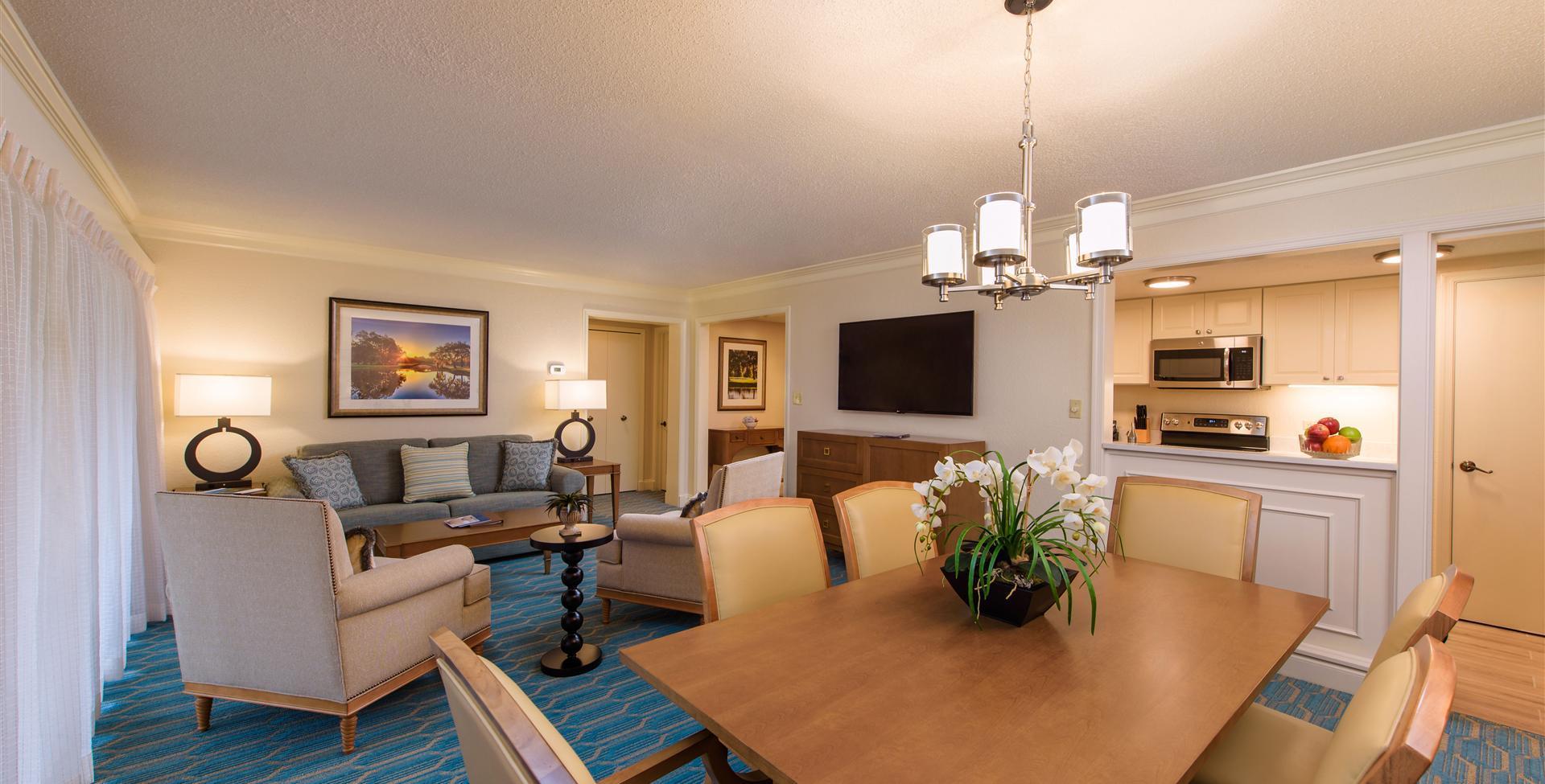 Living room in one of the villas equipped with a living room, flat screen TV, dining table and kitchen
