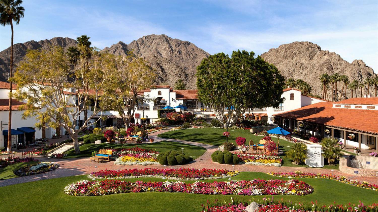 Panoramic view of La Quinta's outdoor garden with ma y vibrant coloured flower beds