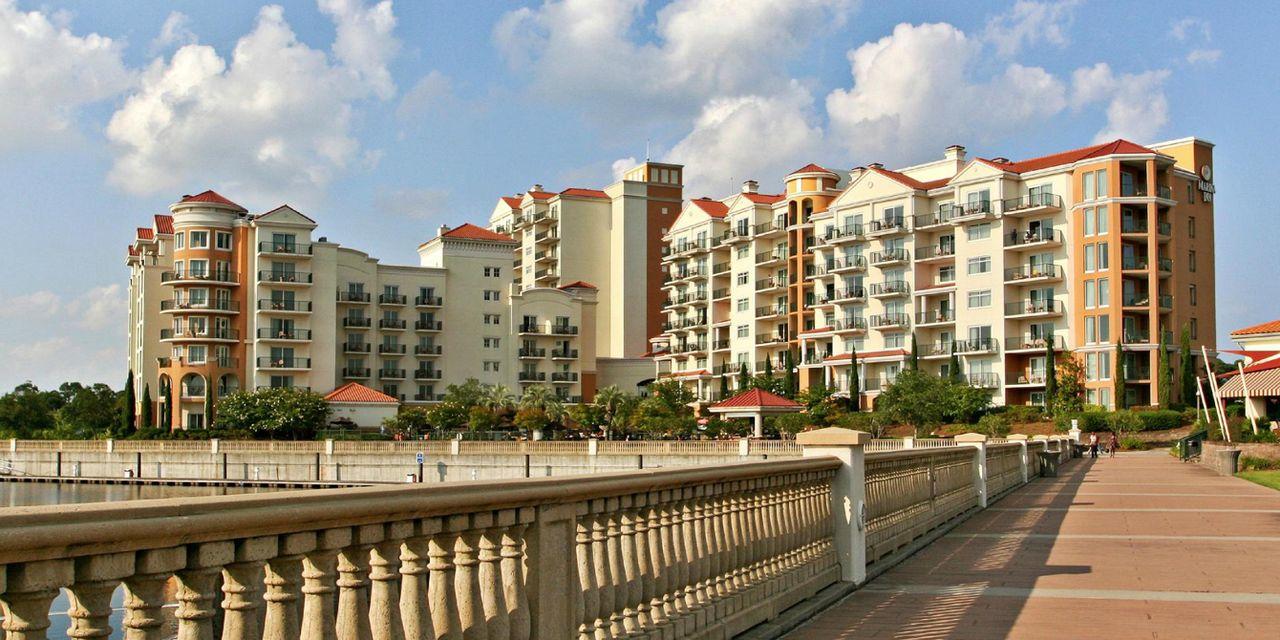 Panoramic view of the Marina Inn building towering over the walk path