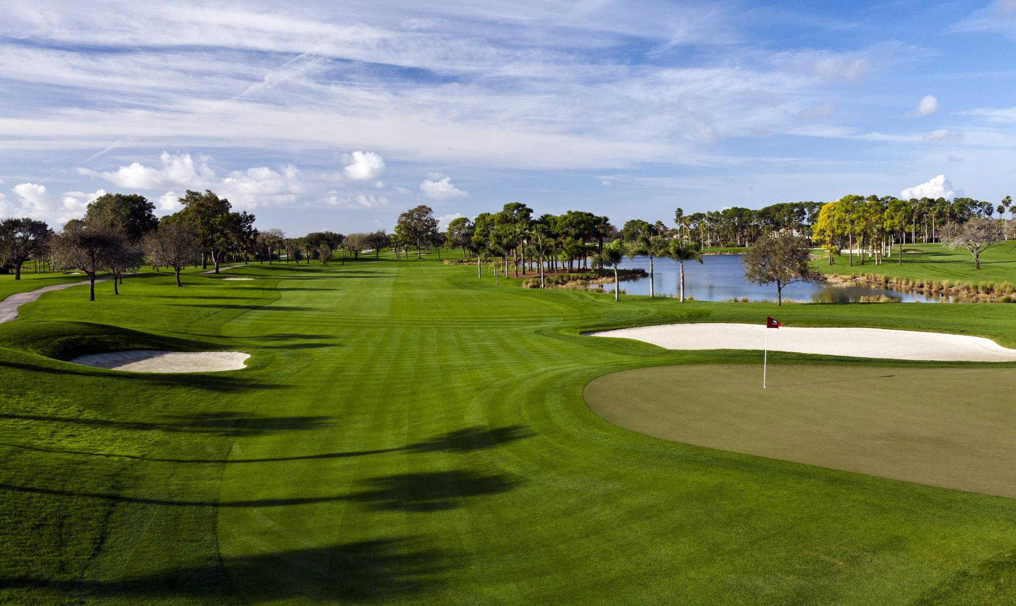 Wide straight fairway leading to well-maintained green neighbouring a large sand bunker