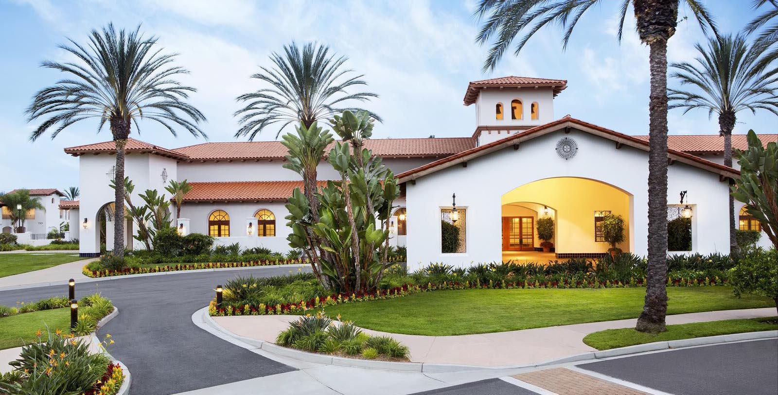 One of the many buildings as part of the Omni La Costa Resort with vibrant flowers planted outside of the building