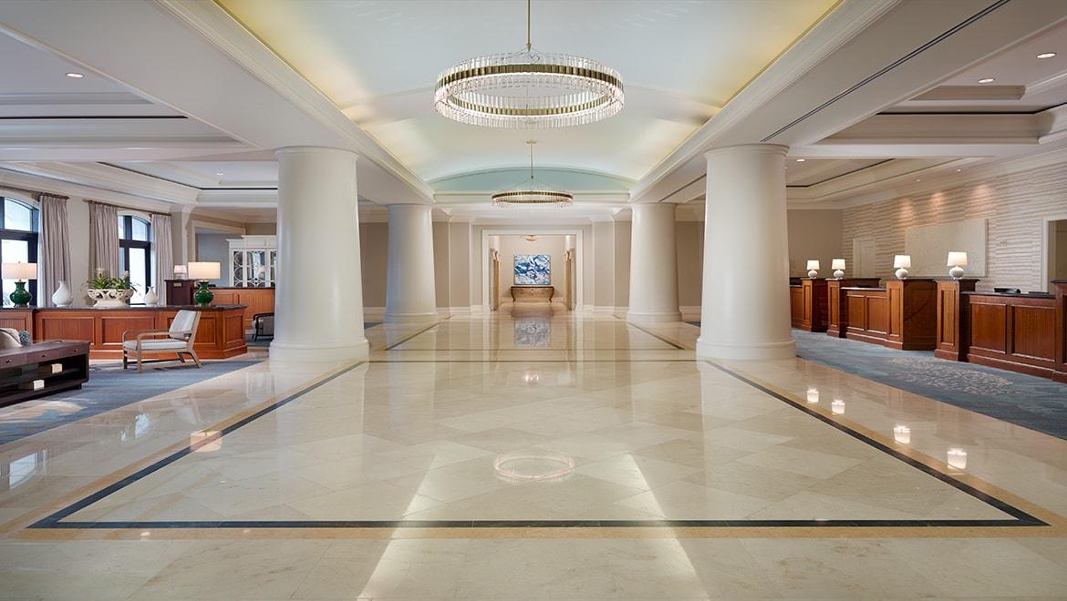 A very spacious reception at the Omni Orlando Resort with large pillars and beautiful chandlers
