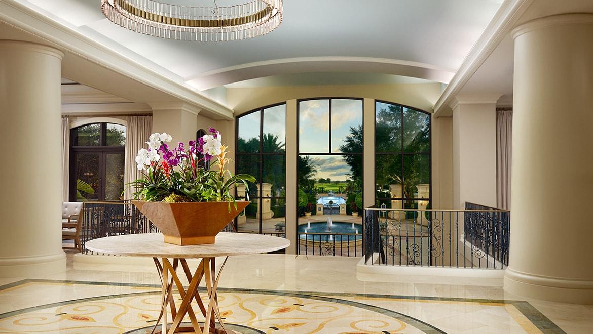 Grand entrance to the Omni Orlando Resort at ChampionsGate with a water fountain in the front