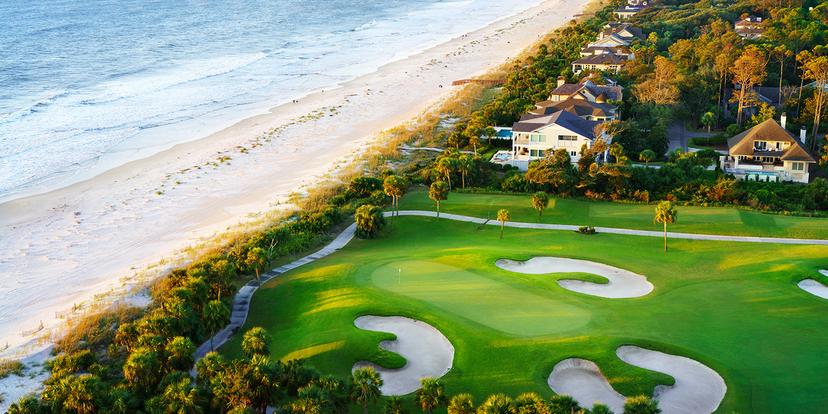Aerial view of the golf course leading to the beach with sea views