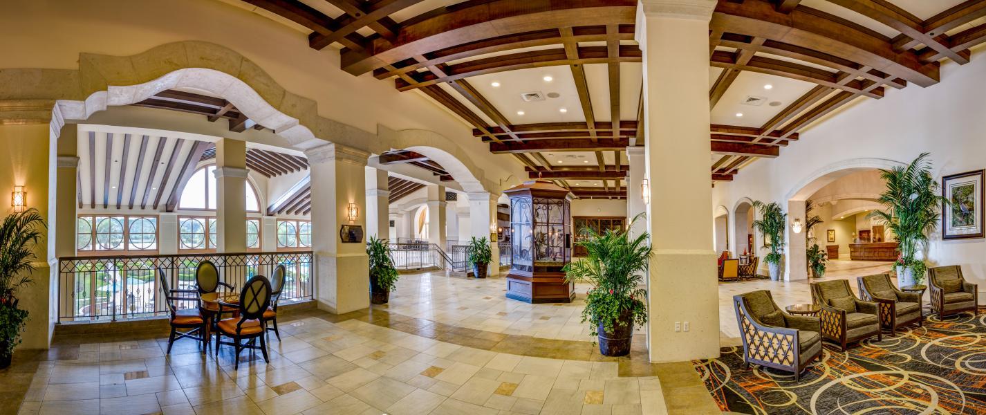 Lounging area and reception at the hotel with tall ceilings, grand pillars and panoramic windows