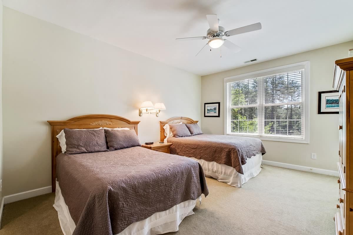 Twin double bed room with brown bed sheets