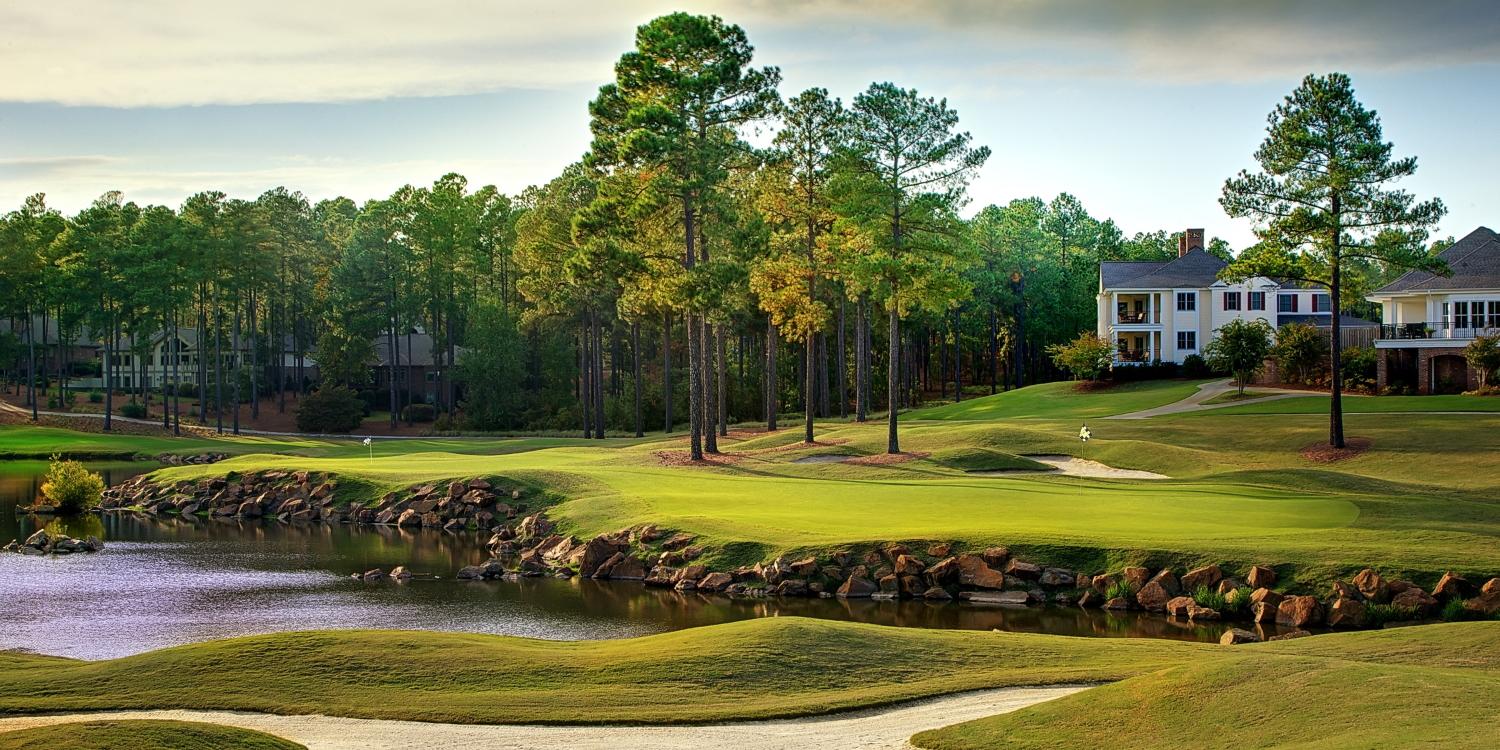 Smooth green separated from the fairway by a water hazard