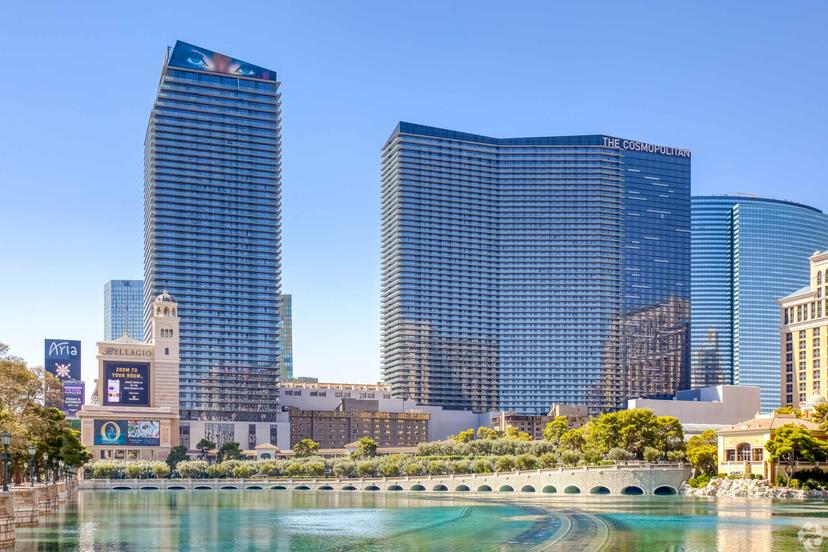 Panoramic view of the Cosmopolitan sky scraper building towering over a small lake