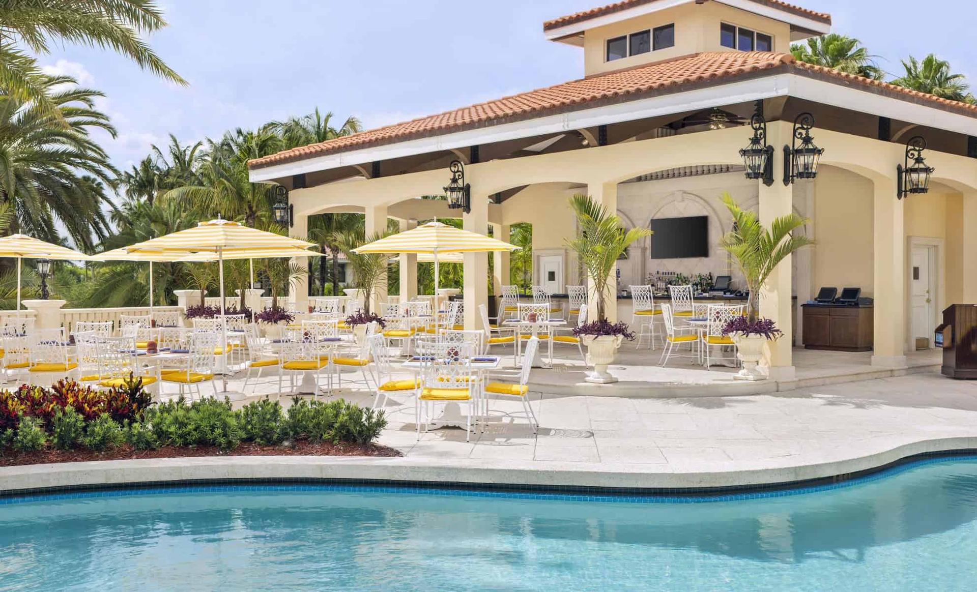 Outdoor bar and poolside lounging area at the resort