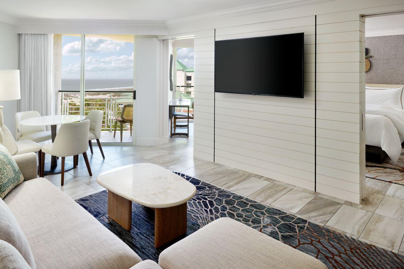 Double bed suite leading to the living room with a patio for sea views and flat screen TV