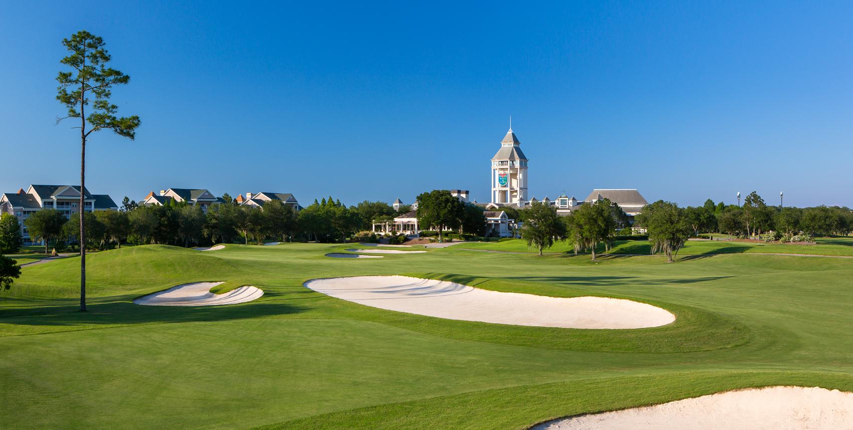 Panoramic view of the World Golf Course under blue skies with the World Golf village resort building towering over