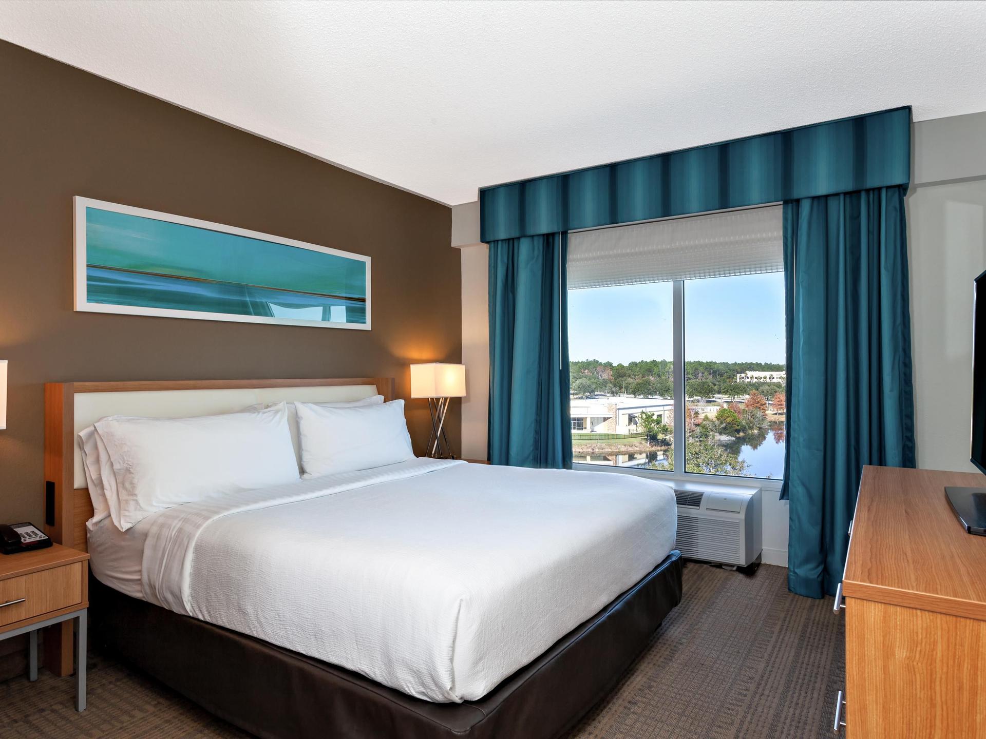 Double bed suite at the World Golf Village with a simple design and window view of the course