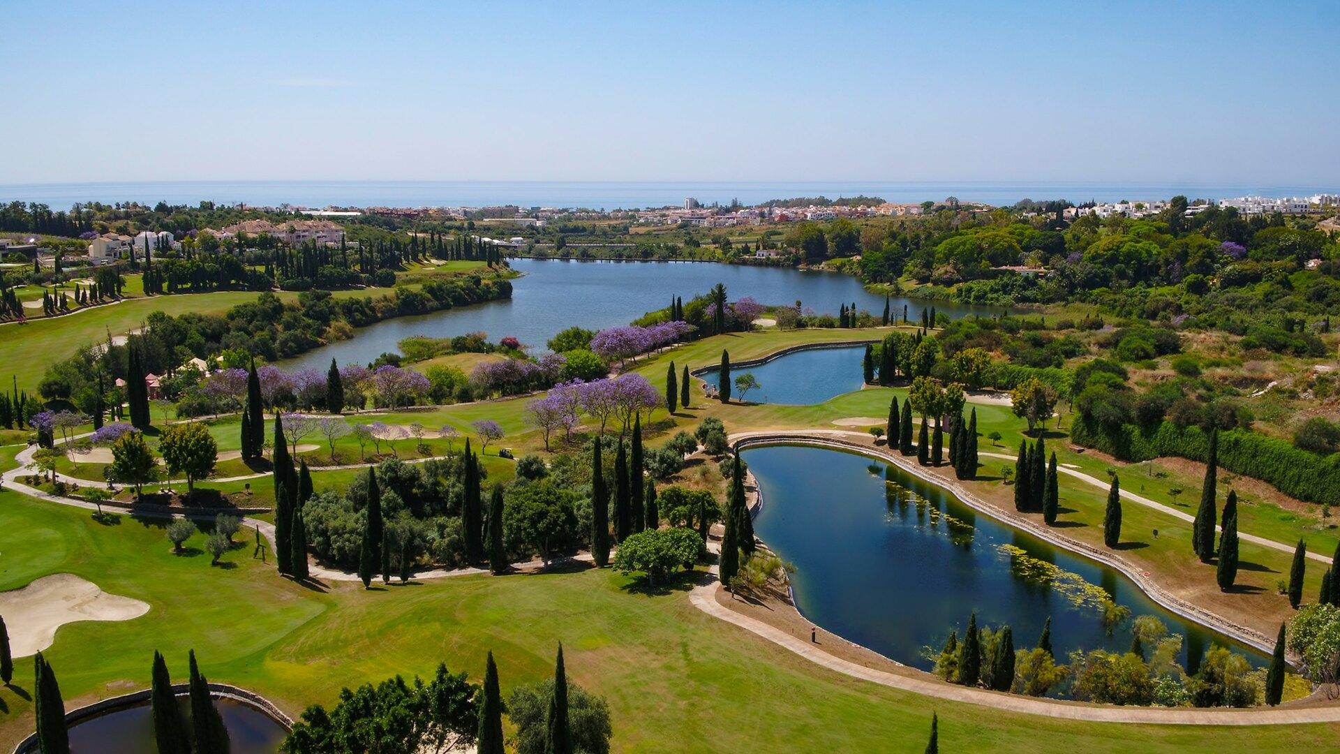 Aerial view of golf course showing multiple water hazards