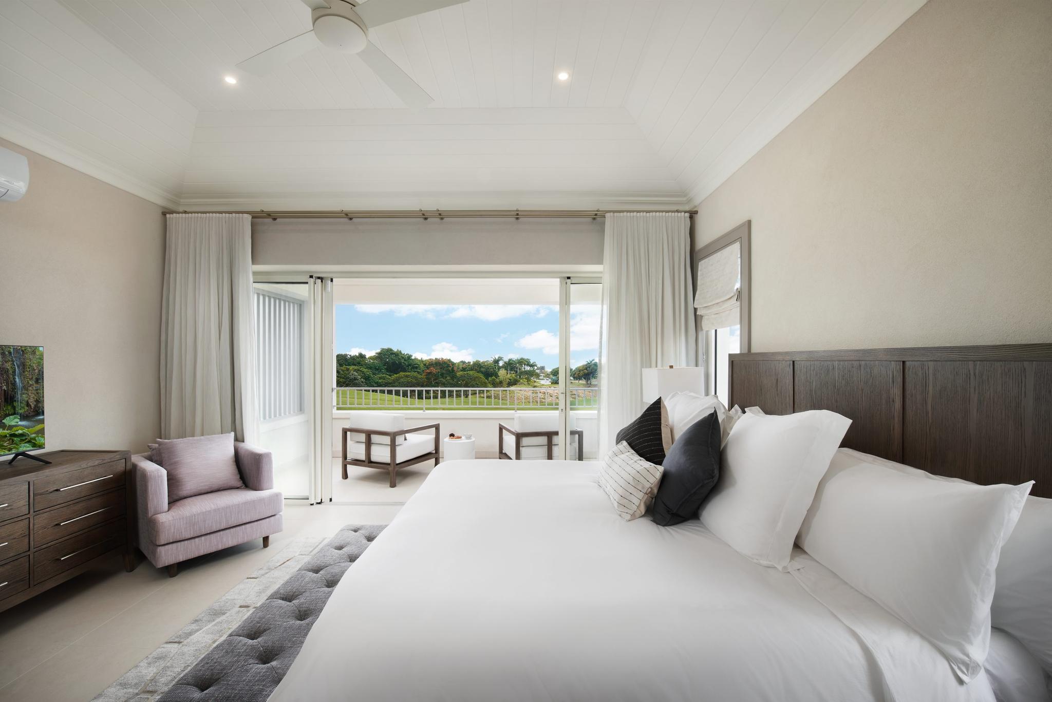 King sized bed room with balcony views of the surrounding nature