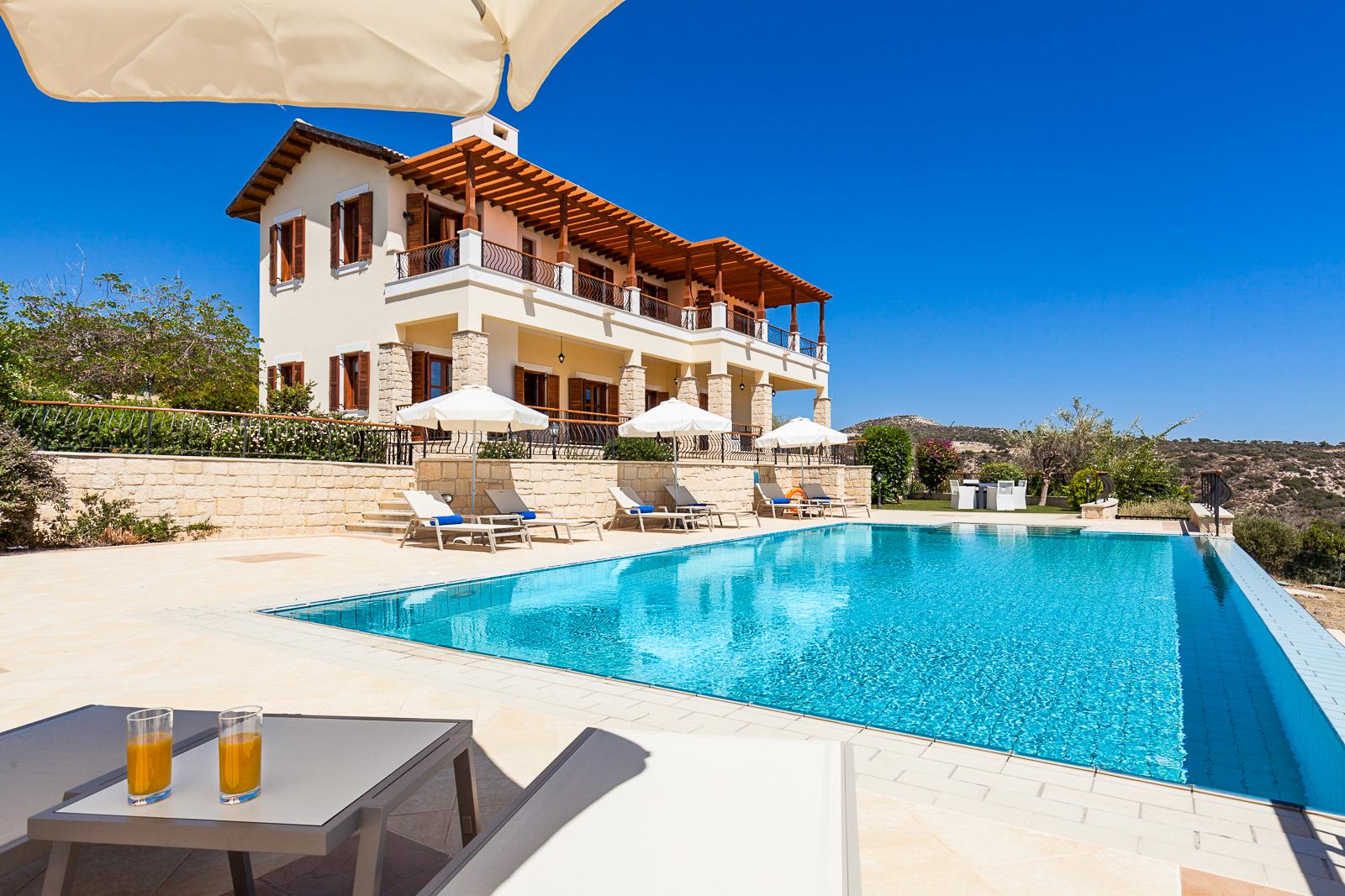 Large outdoor swimming pool with one of the resort buildings towering over