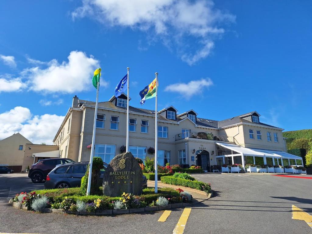 Driving entrance to the lodge with the EU flag among others swaying in the wind