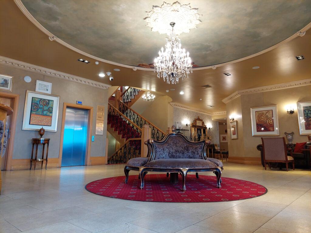 Lobby at the Bellyliffin Lodge has a rustuic feeling with a majestic chandelier