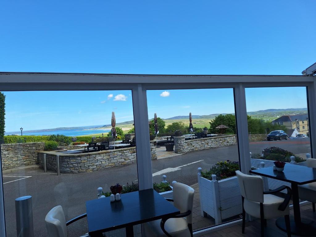 Restaurant at the Ballyliffin Lodge with a roofless feature to soak in the weather and wide windows so you can get a view of the sea