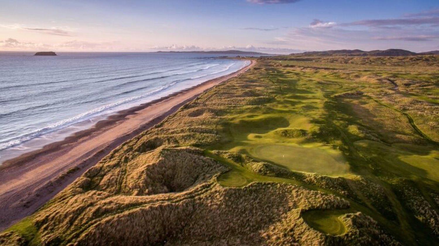 Birds-eye view of the Ballyliffin old course with its hilly landscape and a lovely beach view