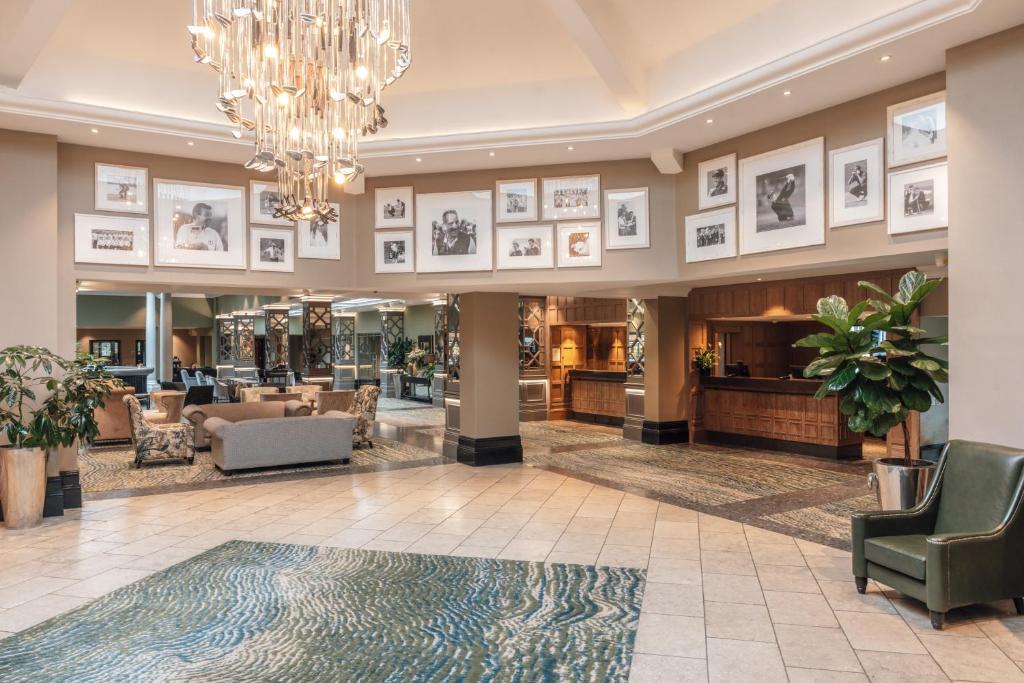 Reception at The Belfry hotel with a grand chandler, golf related artwork and a lounging area
