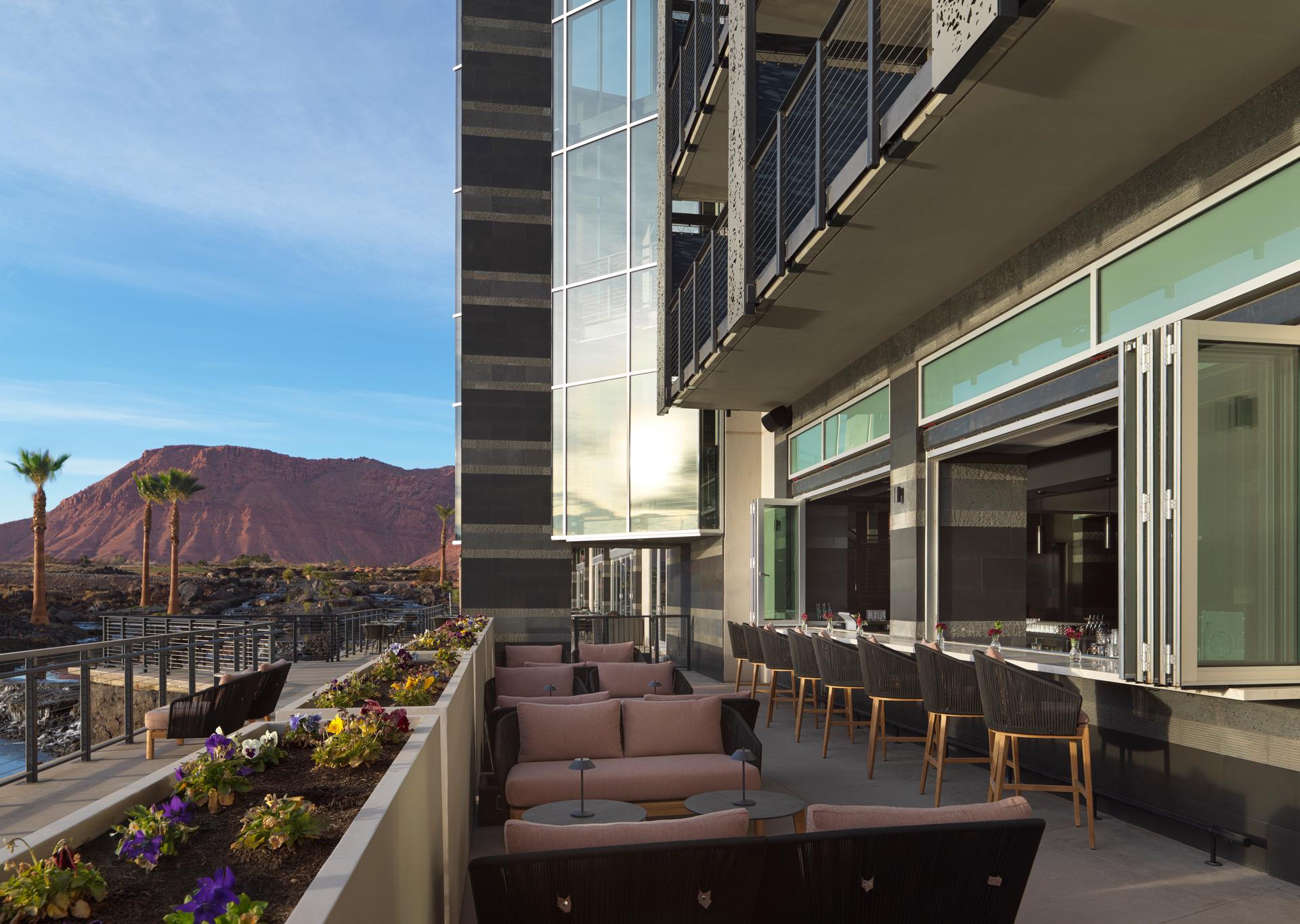 Outdoor seating at the Black Desert Resort with mountain views in the distance