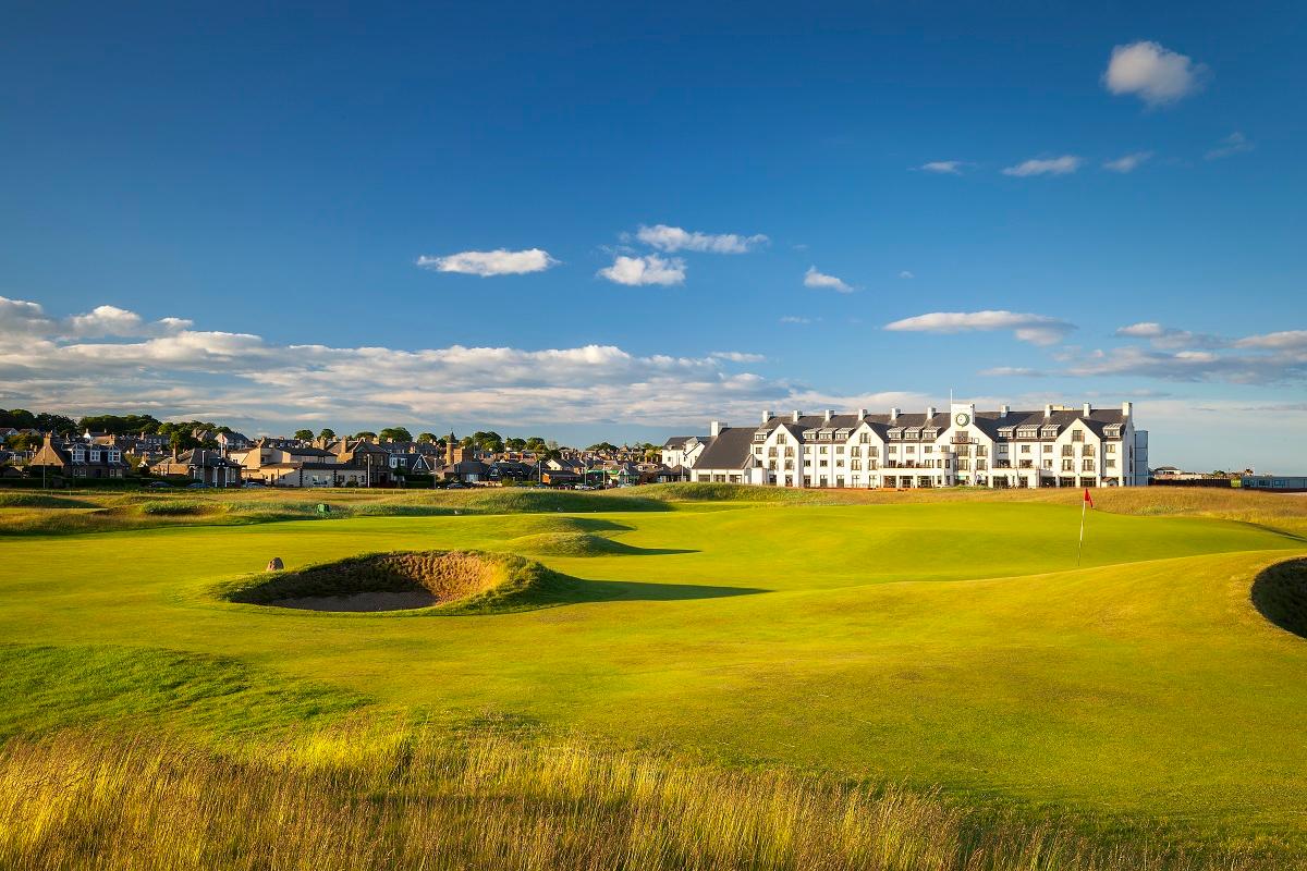 Clubhouse looking over the smooth greens with local town to the left