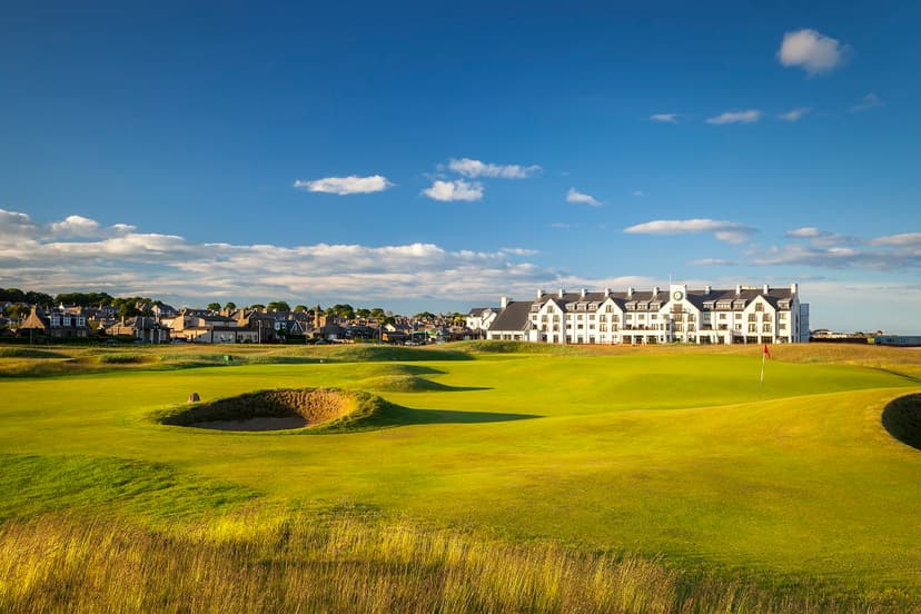 Clubhouse looking over the smooth greens with local town to the left