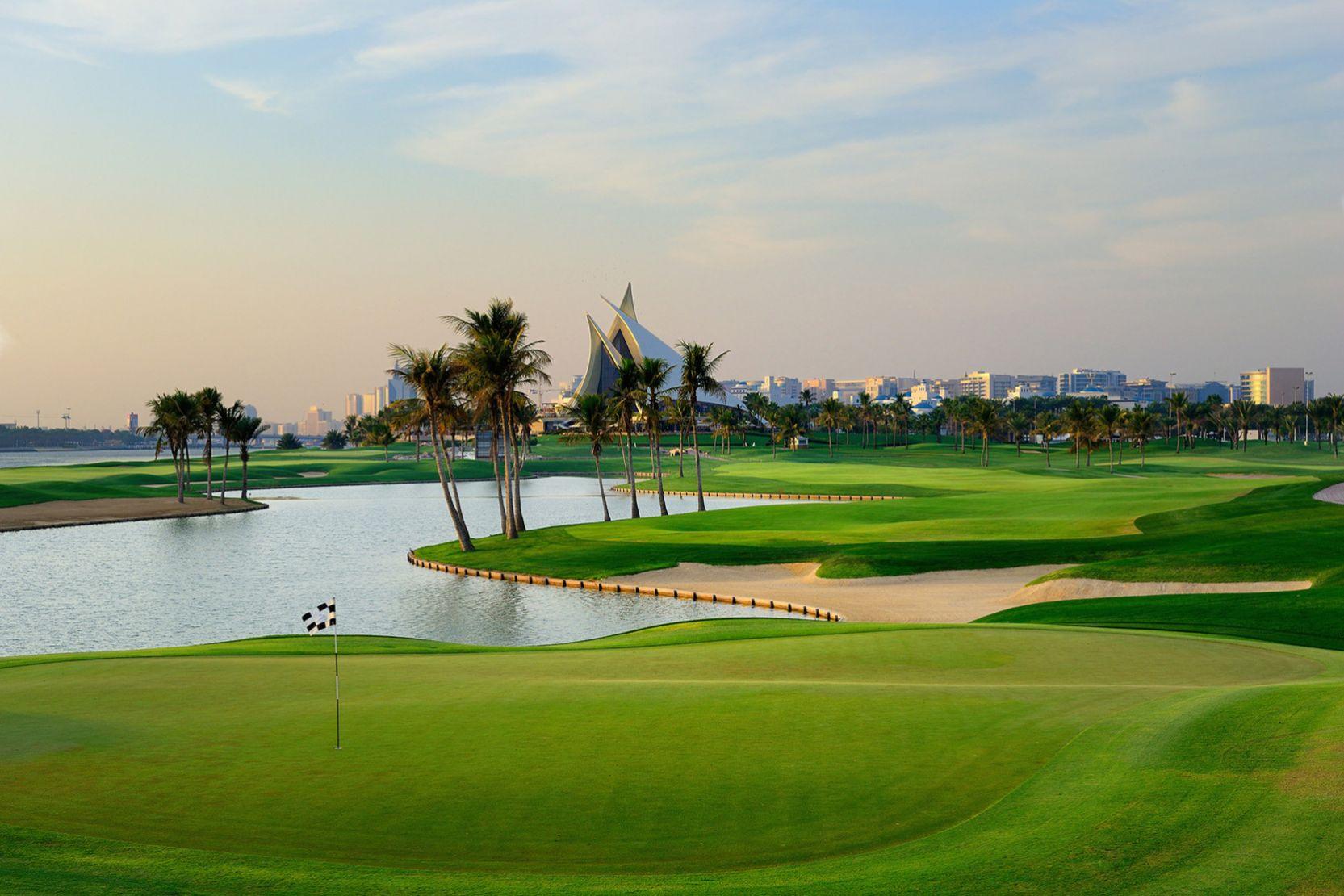 A winding fairway farmed by palm trees leading to a smooth green