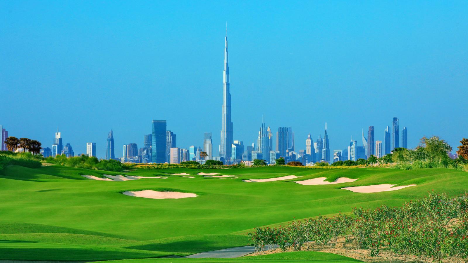 The Duabi Burj Khalifa amongst other sky scrapers towering over the Dubai Hills Golf Club course