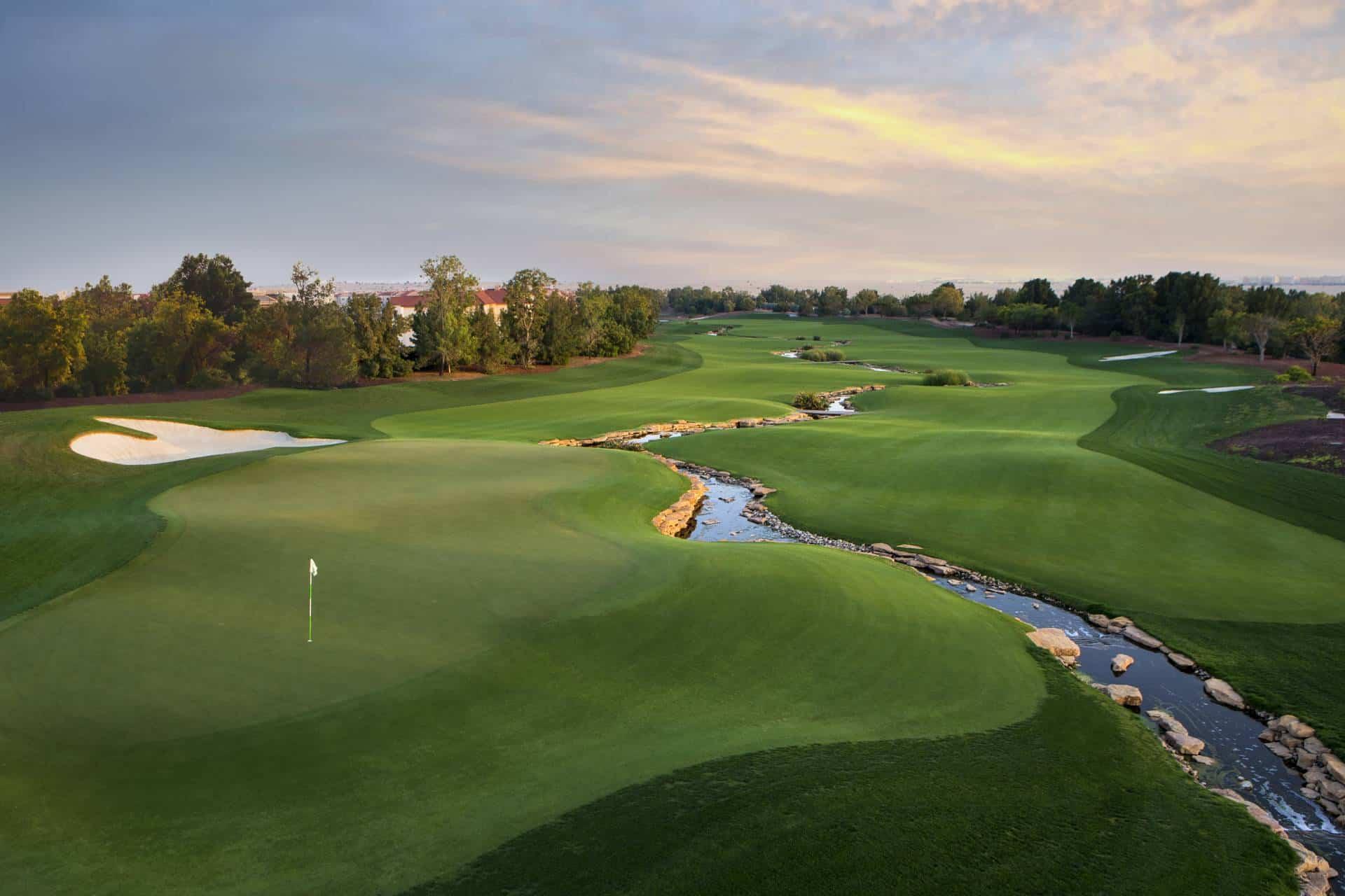 Dubai Earth Golf Course fairway with clubhouse in the distance