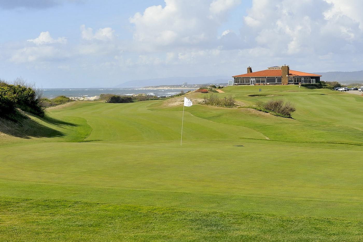 Winding fairway leading up to the green with the clubhouse in the background