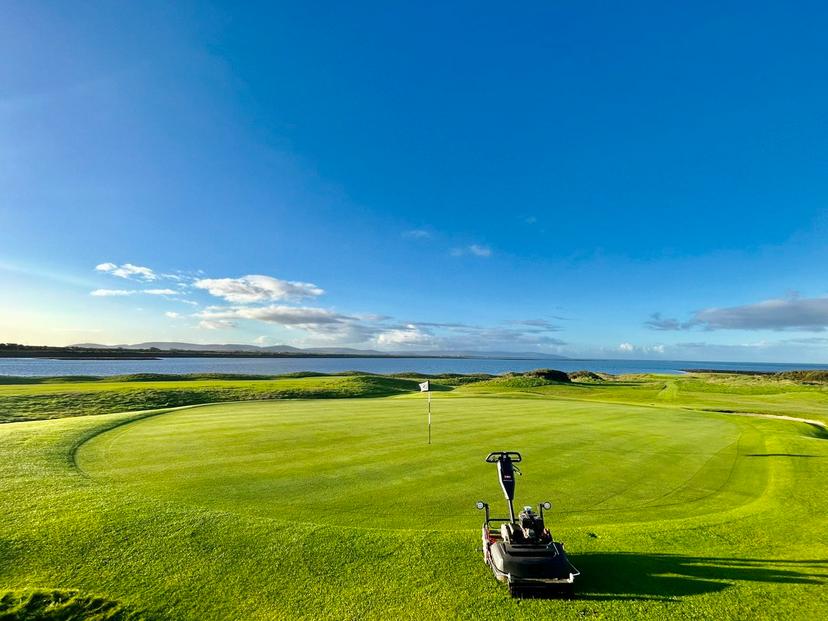 Wide angle view of the putting greens with a beautiful blue sky looking down on the course