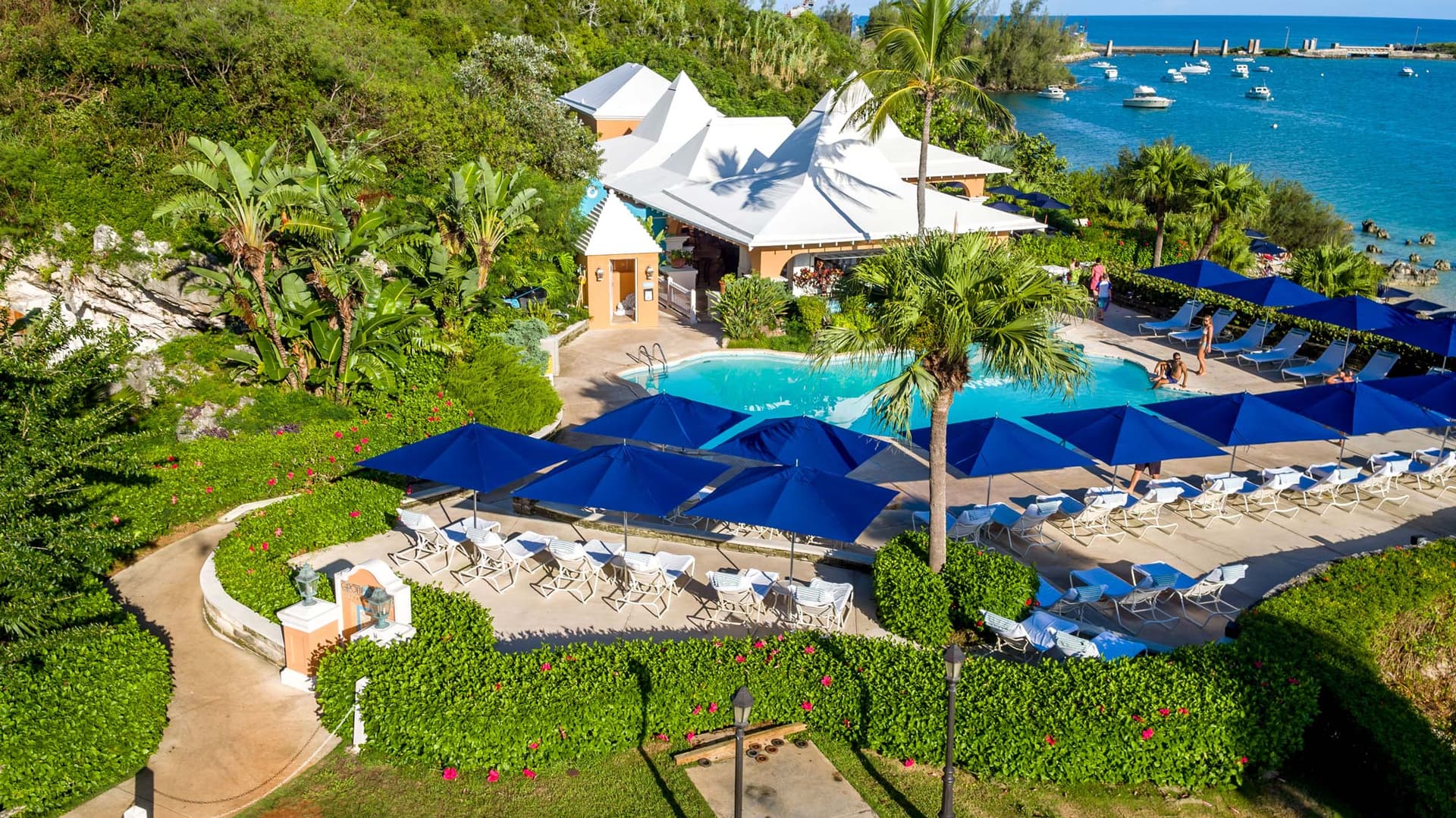 Panoramic view of the resorts swimming pool surrounded by sunbeds