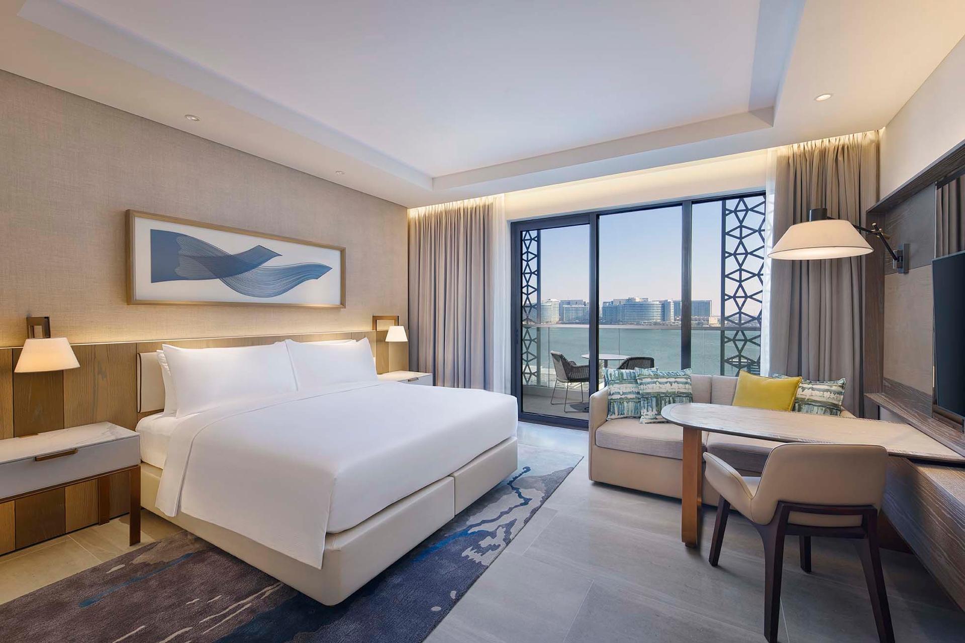 A double bed room at the hotel with balcony views of the sea