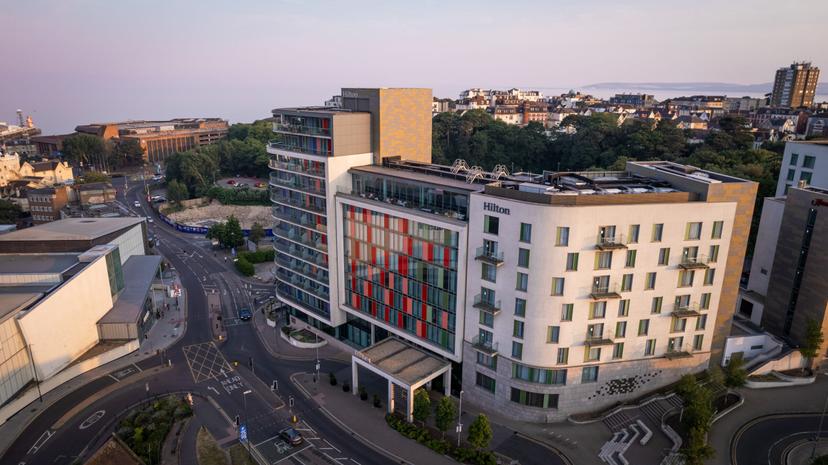 Aerial view of the Hilton Bournemouth showing its large building designed with multicoloured windows