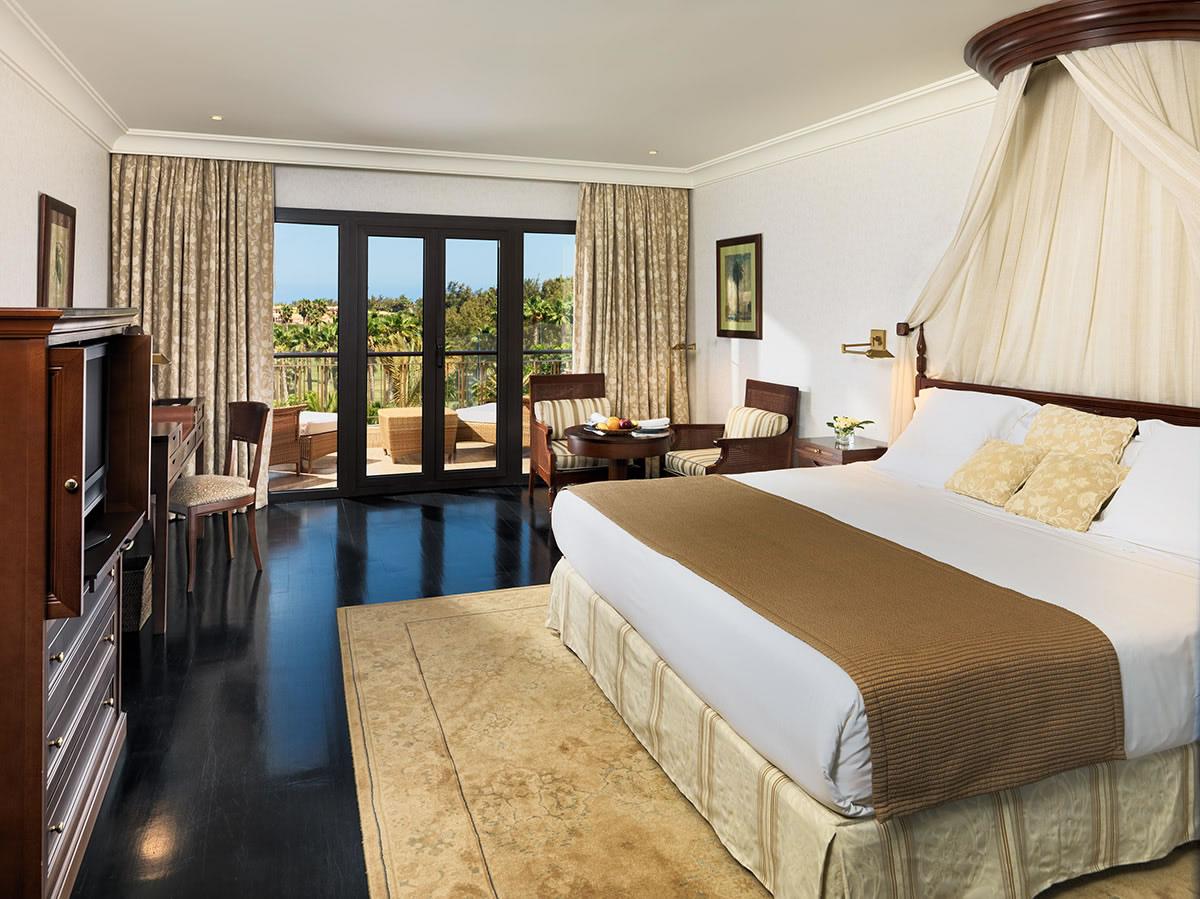 Doubel bed, furniture and a balcony in a Double Room