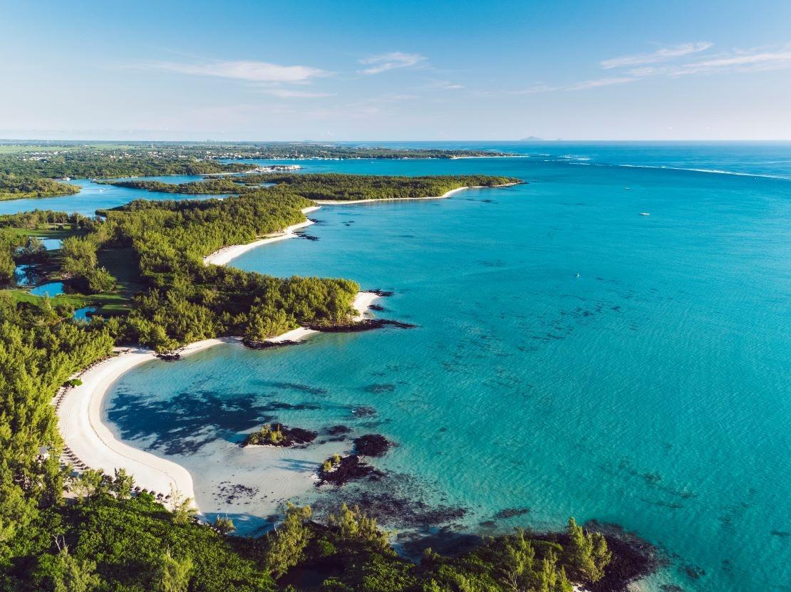 Overhead view of a beach littered with sunbeds at the Ile Aux Cerfs resort