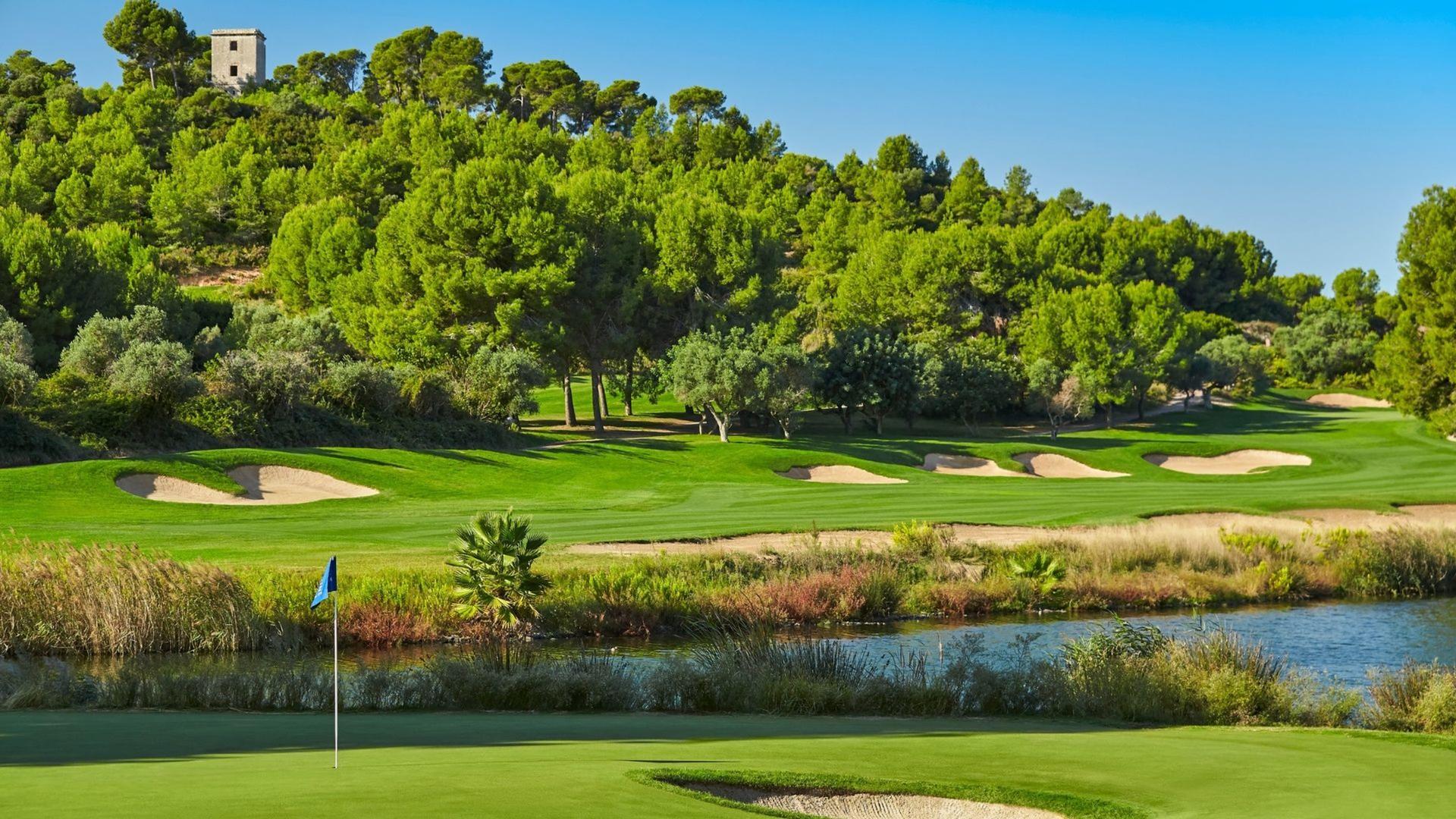 View from the green showing a difficult approach shot over water