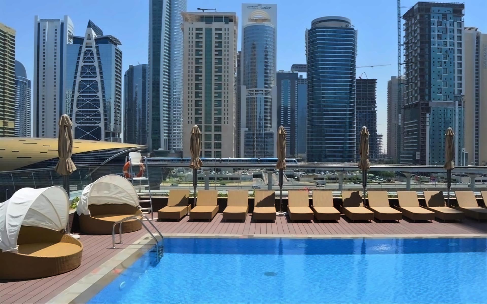 Pool deck with city skyscrapers in background