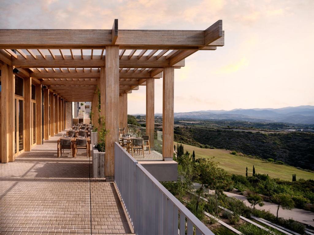 An outdoor balcony dining area with mountain views in the distance
