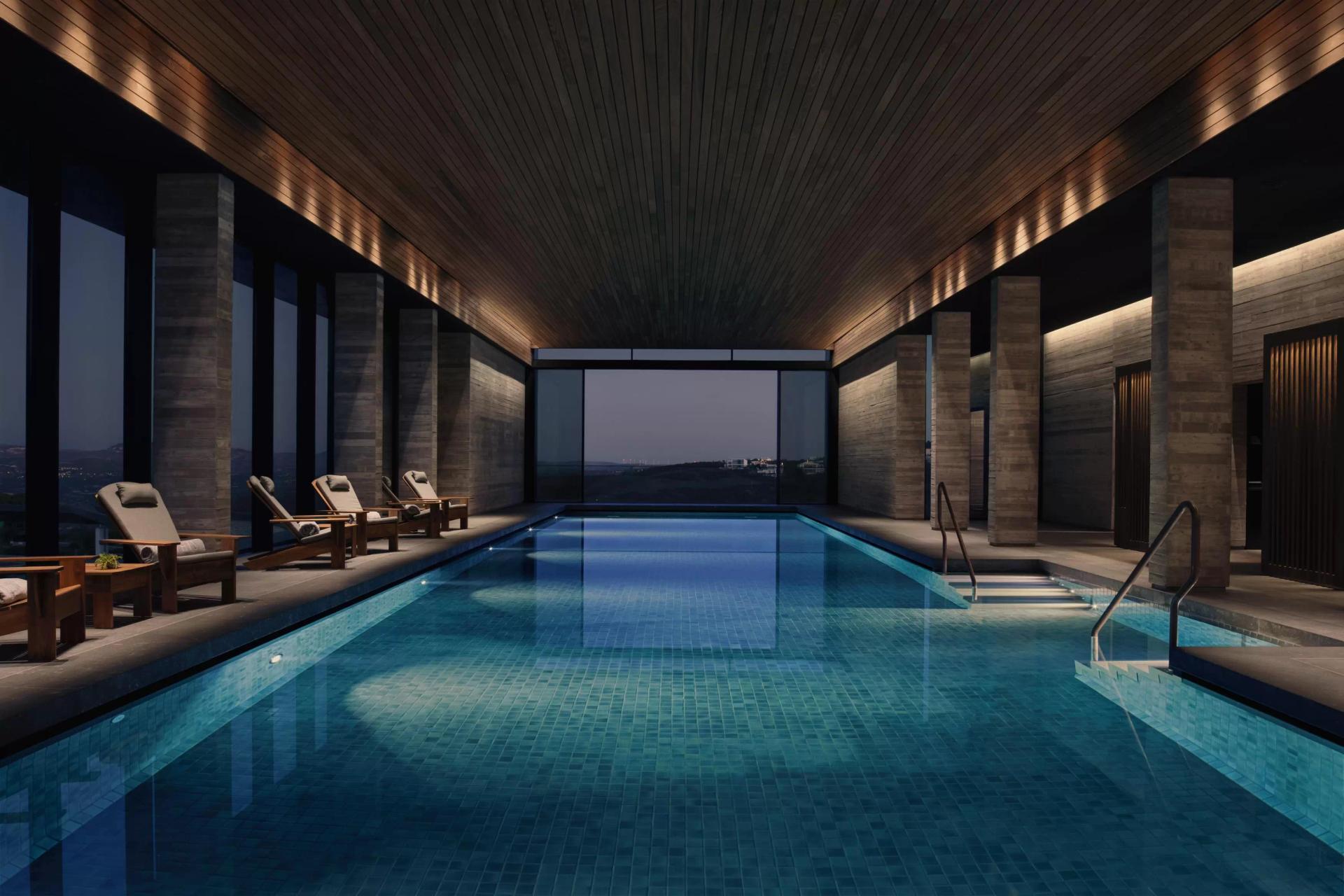 Indoor swimming pool at Minthis Resort with a panoramic window