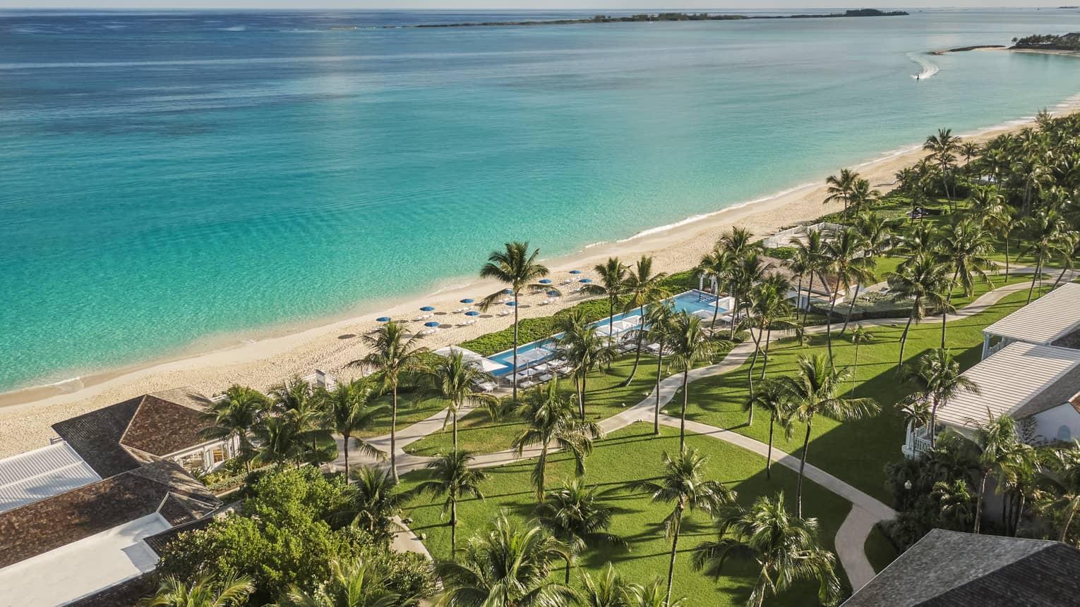 Overhead view of the resort building with a walk path leading to the beach