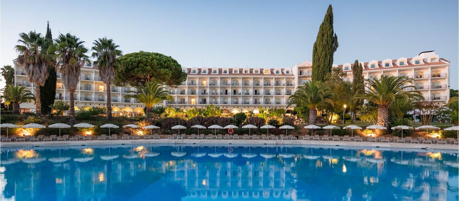 Outdoor swimming pool with the hotel in the background