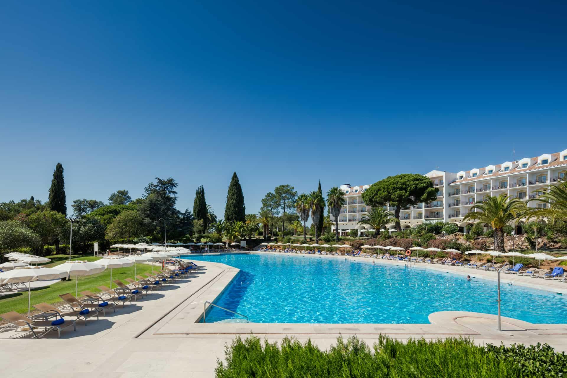 Outdoor swimming pool with the hotel behind