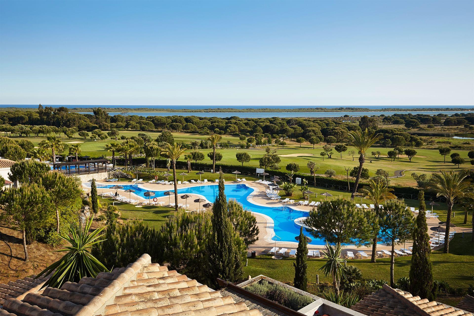 Outdoor swimming pool with El Rompido golf course