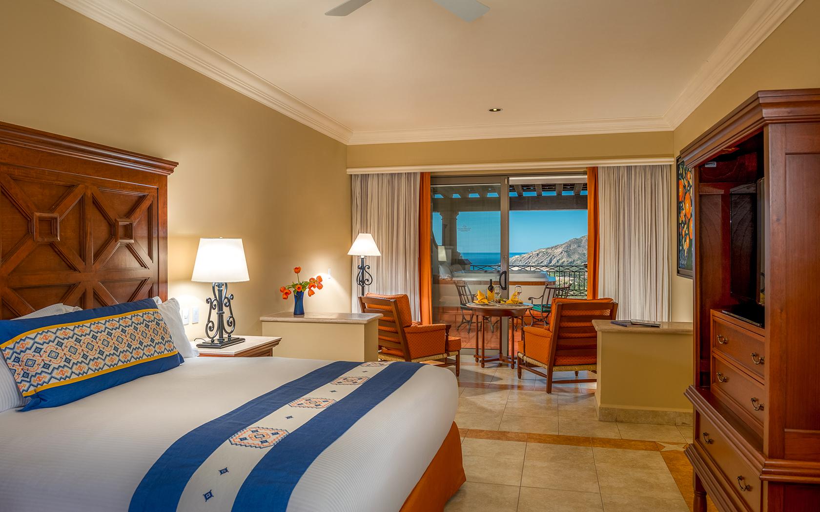 Double bed room at Pueblo Bonito Los Cabos Resort with balcony views of mountains and the ocean