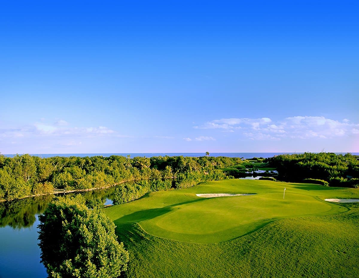 Panoramic view of the sun shining down on a well-maintained green