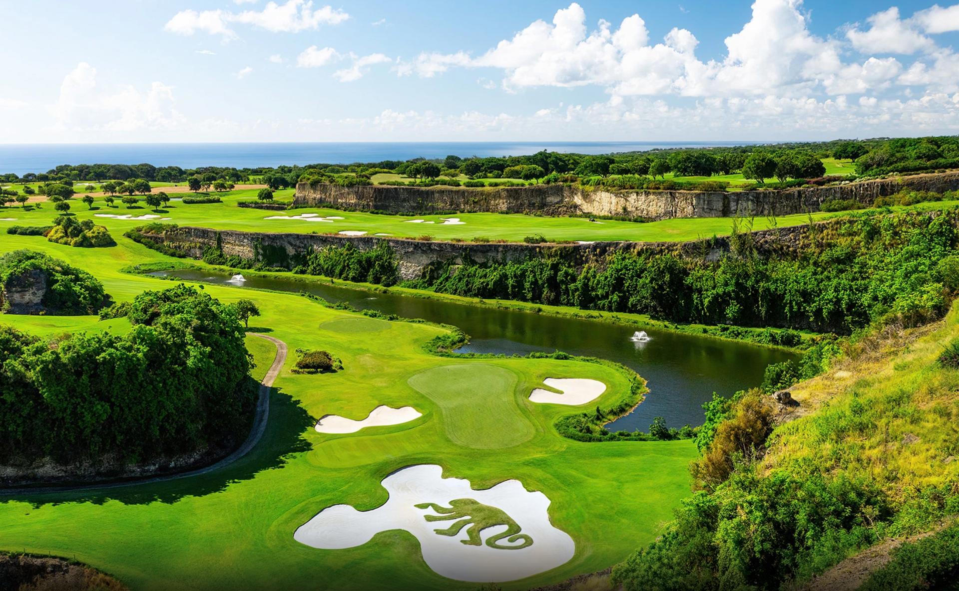 Stunning fairway design with dramatic elevation changes, sand bunkers, and vibrant greenery surrounding the pristine landscape.
