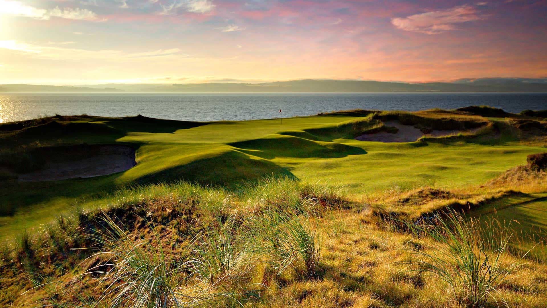Well-Maintained greens with coastal views out to the sea