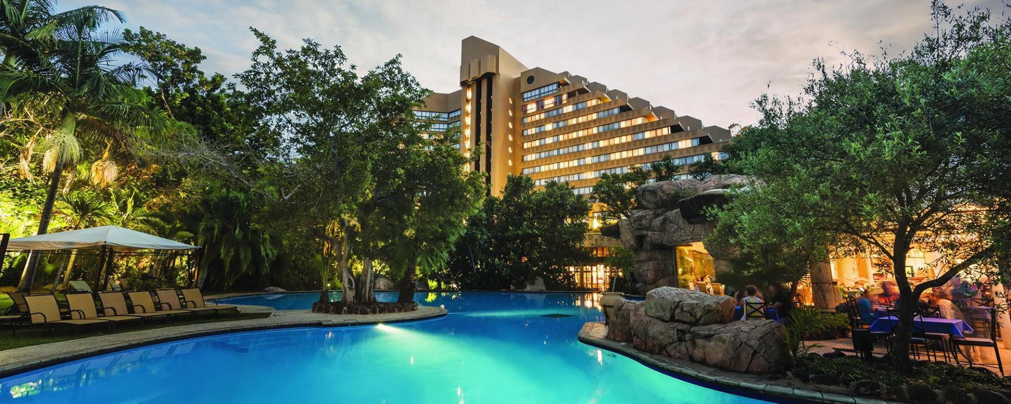 The Cascades Hotel building overlooking their swimming pool